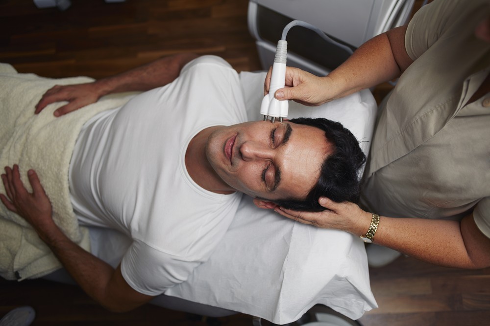 Man laying bed woman holding thermometer